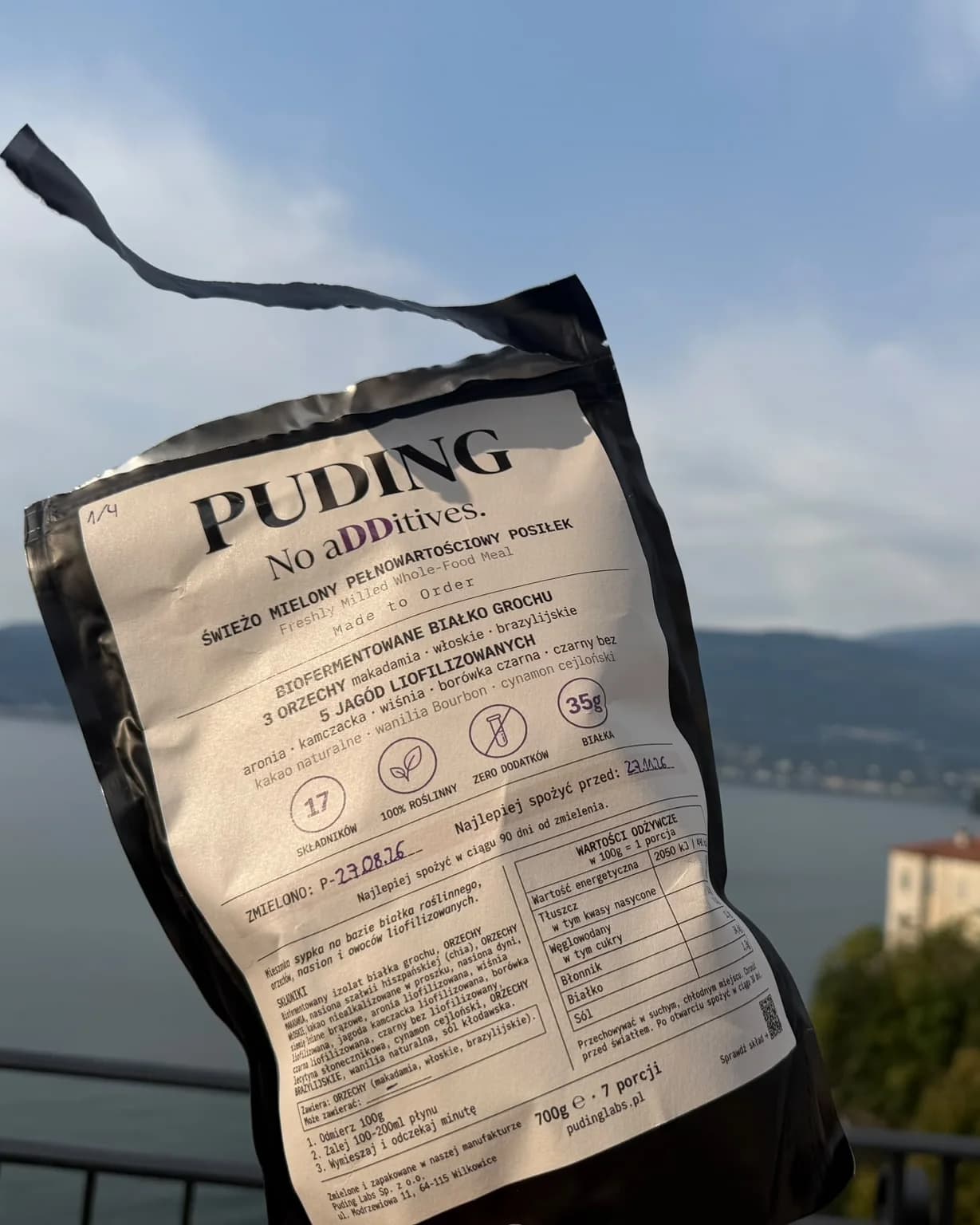 Paczka PUDING nad jeziorem Lago Maggiore, w tle góry i willa